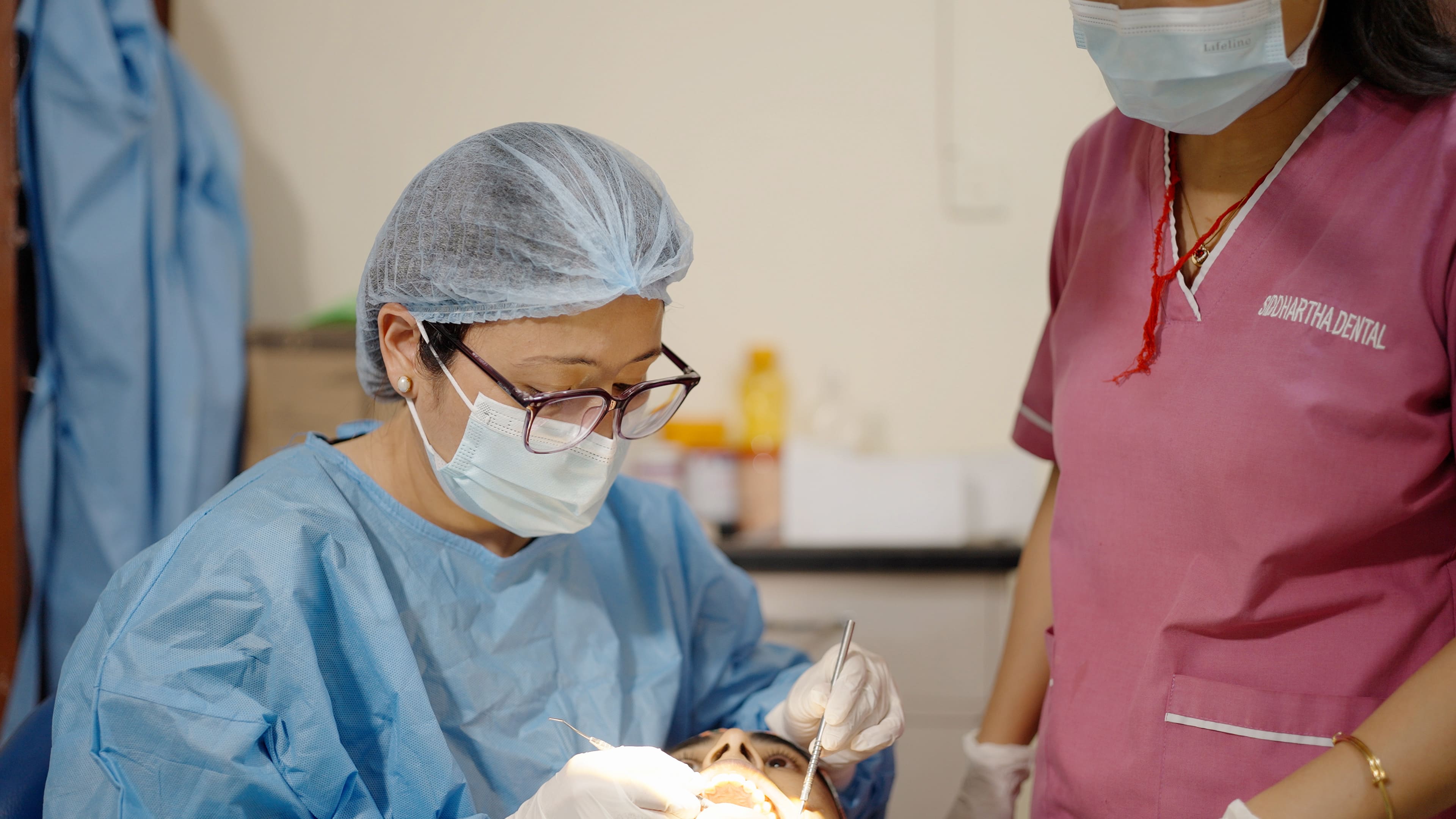 Dentist providing treatment at Siddhartha Dental Clinic